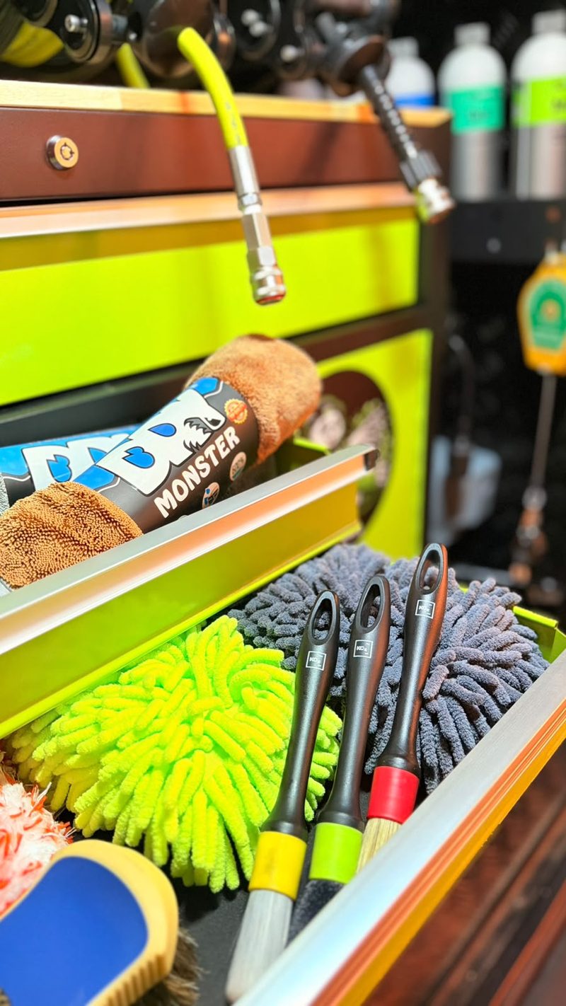 Open drawer with microfibre drying towel, wash mitts and detailing brushes