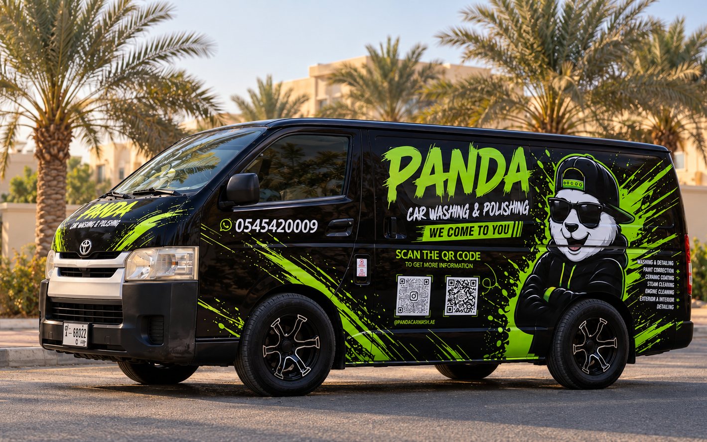 The black Panda Car Wash van, wrapped in the panda logo and lime splashes, parked on a palm-lined street in Ajman