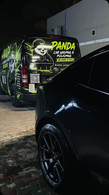 Black car next to the Panda Car Wash van during a mobile job