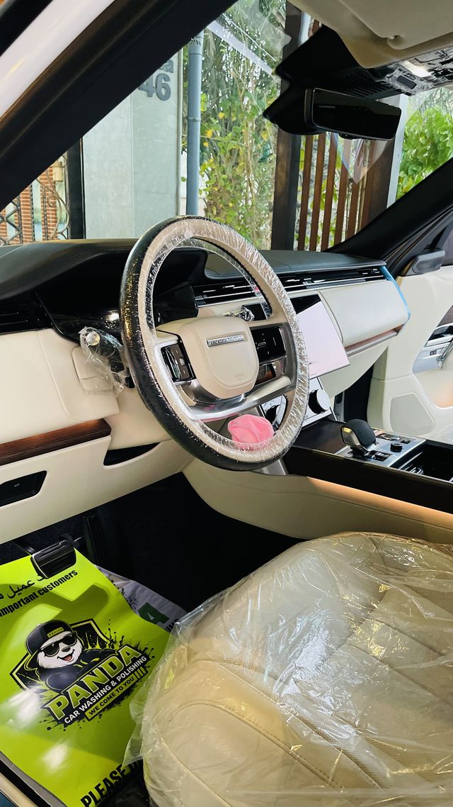 Car interior with Panda seat and steering-wheel covers and a Panda floor mat