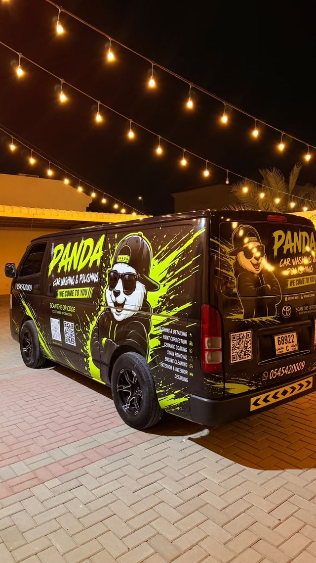 The Panda Car Wash van parked under string lights at night